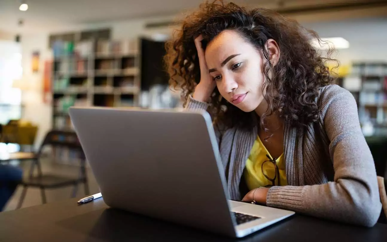 Woman struggling to concentrate at work or school due to Adult ADHD. Woman struggling to concentrate at work or school due to Adult ADHD.