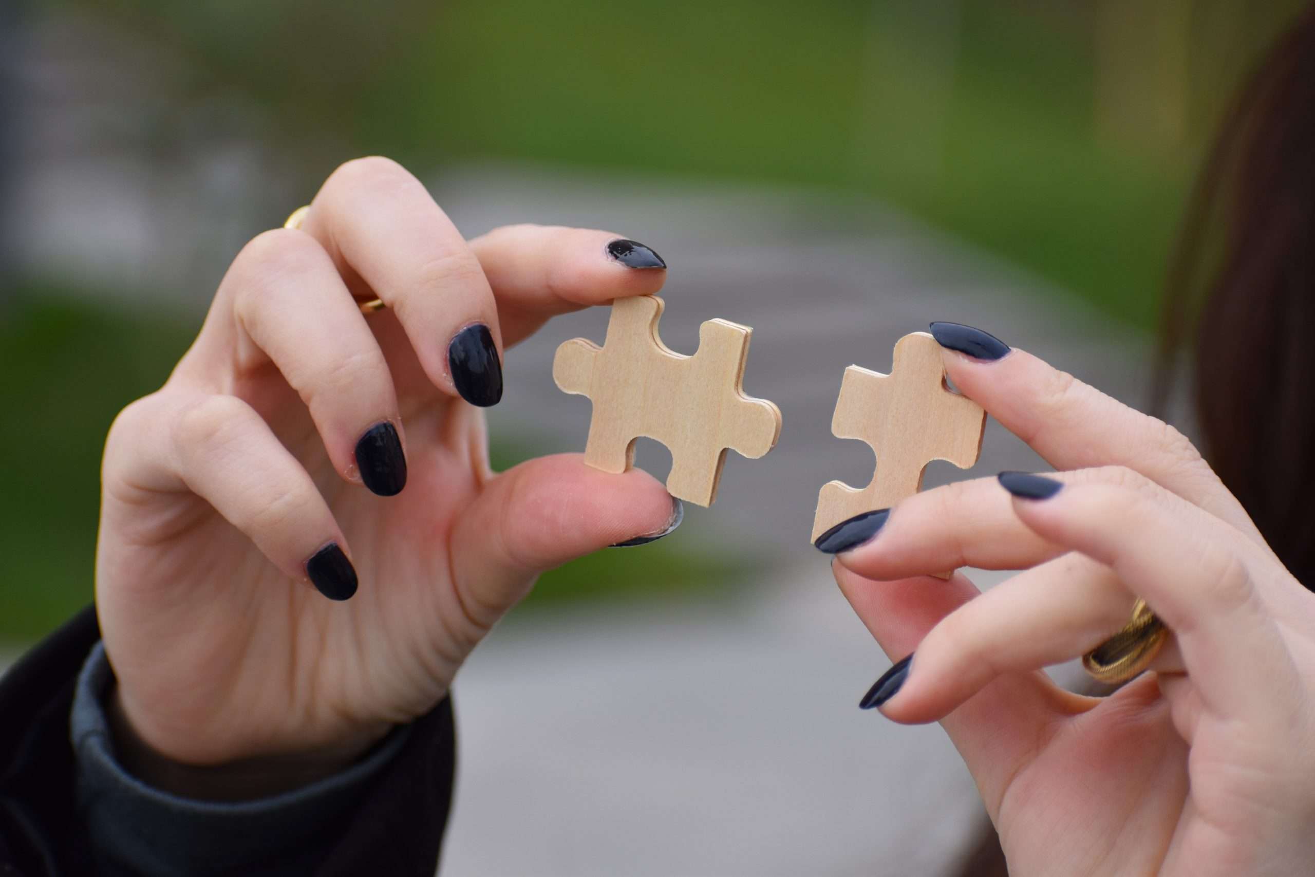 Hands connecting puzzle pieces, representing TMS versus ECT comparison.