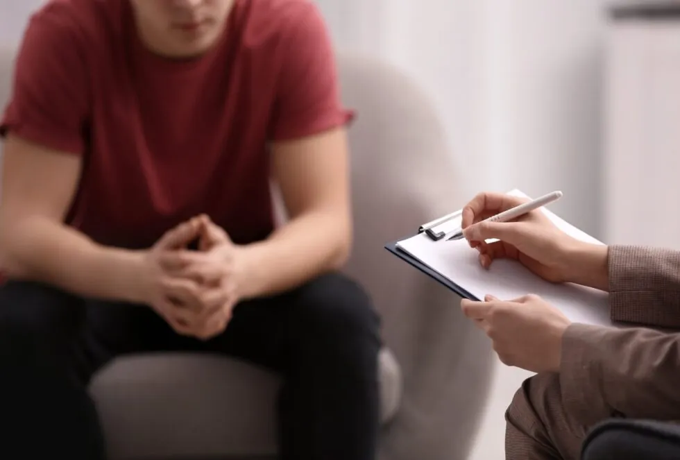 woman looks on anxiously during work meeting