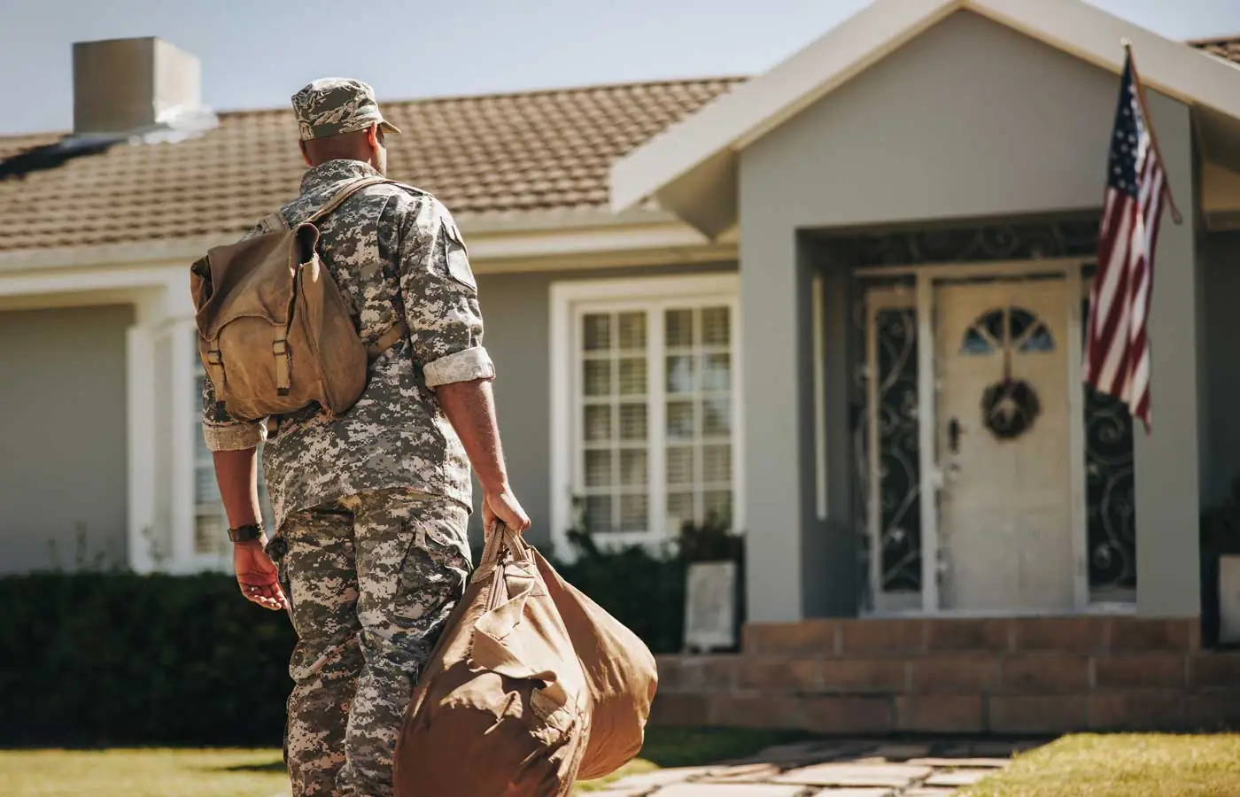 Image of a man in uniform returning home depicting the military transition to civilian life.