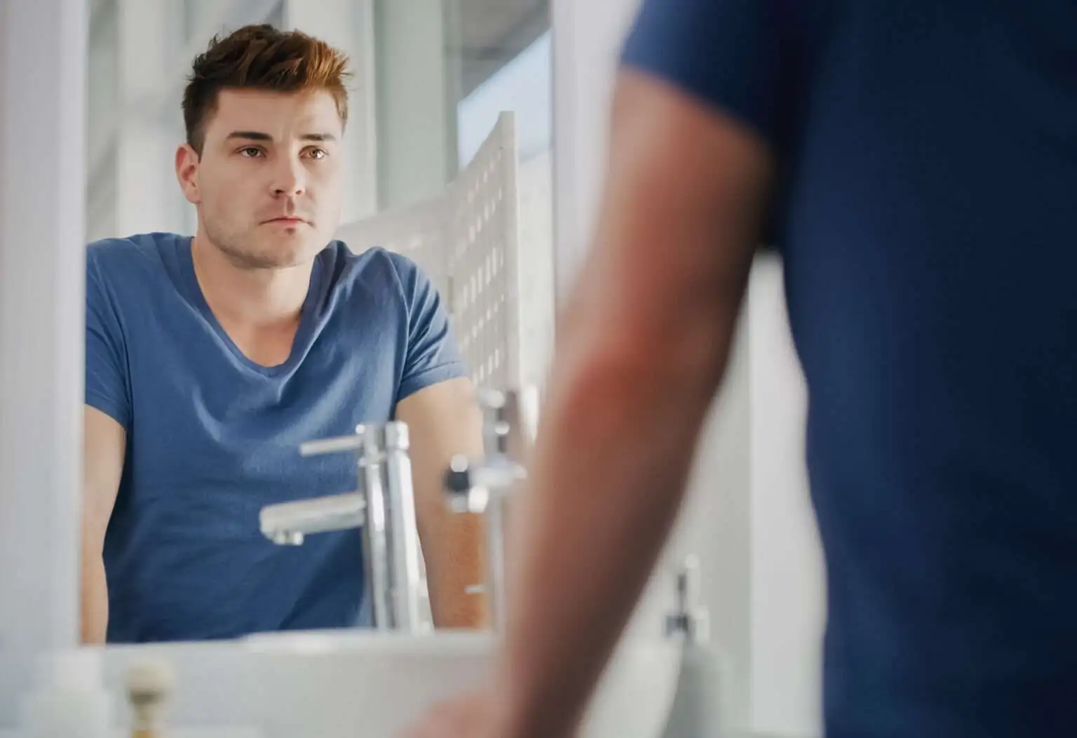 woman looks on anxiously during work meeting